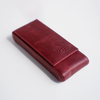 Red leather pen case by Eng Leather Co. with three compartments, designed to securely hold and organize pens.