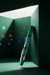 Nahvalur Eclipse fountain pen with emerald and ruby accents, featuring a sleek design and gold nib on a white background.
