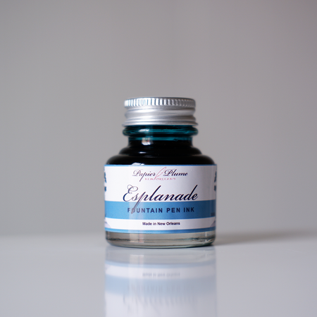 Papier Plume Esplanade fountain pen ink bottle with elegant label, showcasing vibrant ink color and classic design.