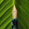 Esterbrook Estie fountain pen ink in evergreen color, shown in a close-up image highlighting the ink's vibrant shade and packaging.