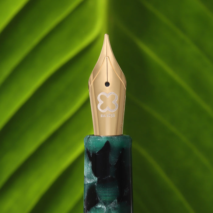 Esterbrook Estie fountain pen ink in evergreen color, shown in a close-up image highlighting the ink's vibrant shade and packaging.