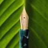 Esterbrook Niblet Evergreen fountain pen ink bottle with green ink visible in the glass container.