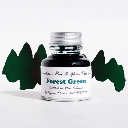 Bottle of Papier Plume forest green fountain pen ink with a clear label, designed for smooth writing and vibrant ink flow.