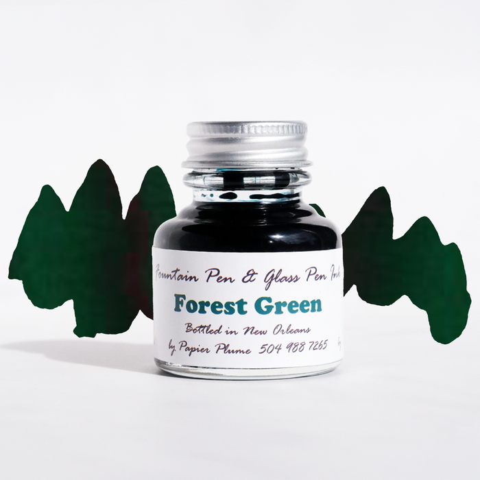 Bottle of Papier Plume forest green fountain pen ink with a clear label, designed for smooth writing and vibrant ink flow.