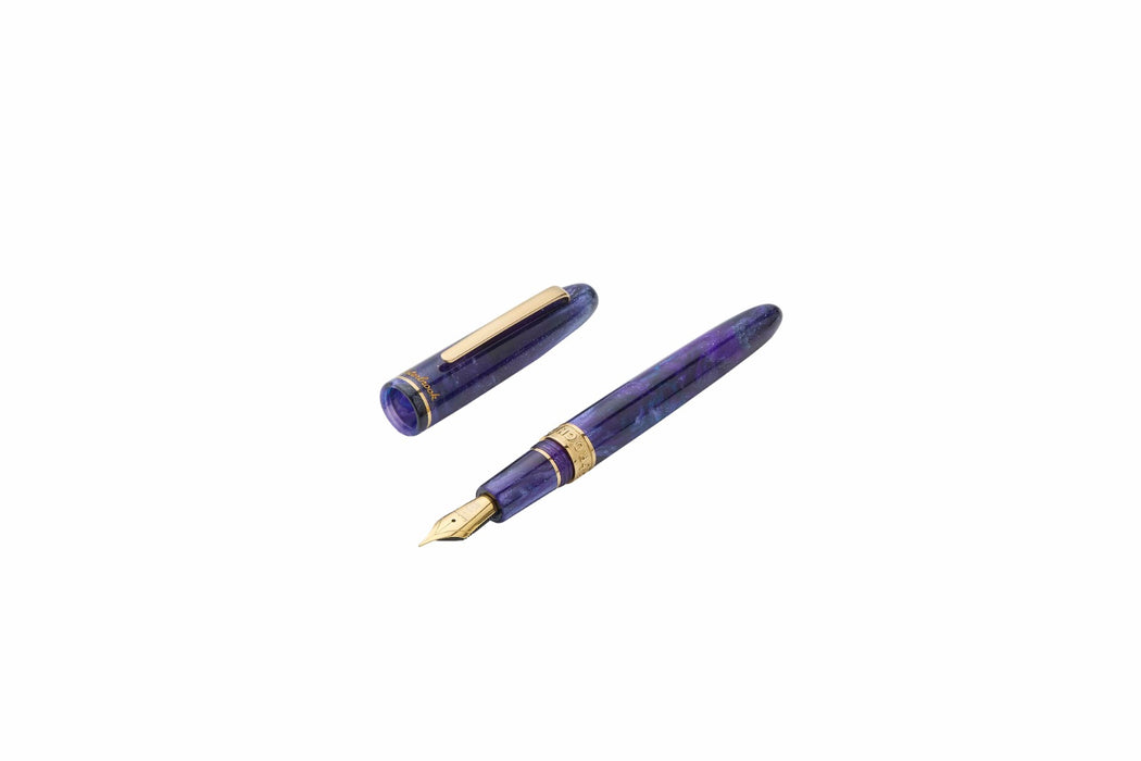 Esterbrook The Rockstar Estie fountain pen with a glossy black and gold design, featuring a metal clip and intricate detailing.