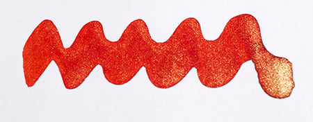Diamine Shimmertastic Firefly fountain pen ink with shimmering, vibrant orange and gold accents in a glass ink bottle.