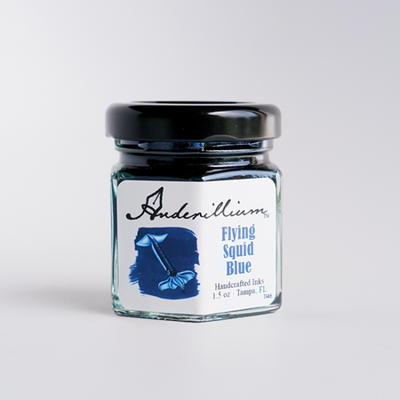 Anderillium Flying Squid Blue fountain pen ink bottle with vibrant blue ink visible inside.
