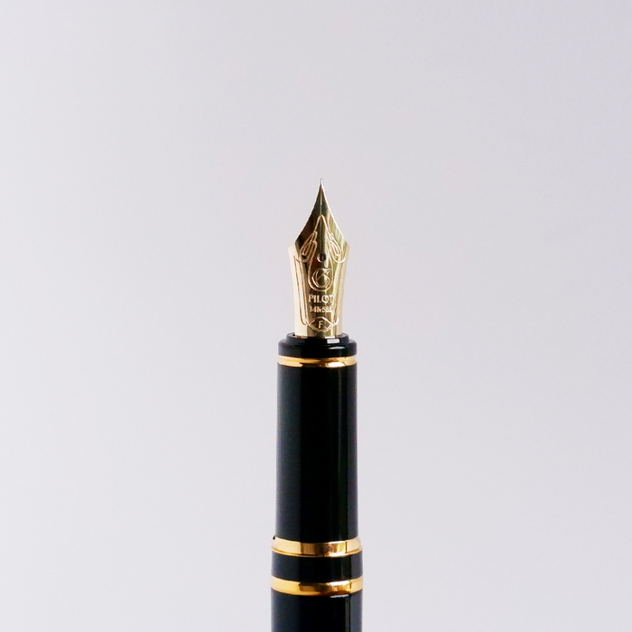 Pilot Grance fountain pen with pearl pink resin body and gold accents, featuring a sleek design and a fine nib.