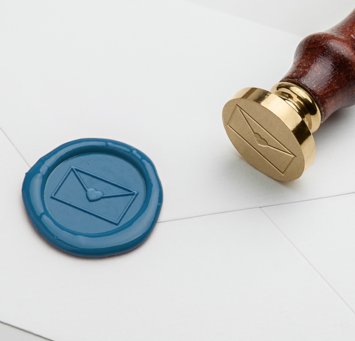 Papier Plume wax seal with heart symbol on letter, featuring a classic wax seal design for elegant correspondence.