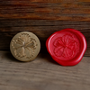 Pink hibiscus flower wax seal with Papier Plume Wax Seal Set, featuring a decorative floral design on a white background.