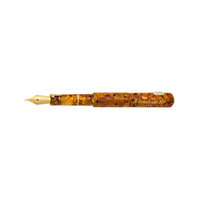 Esterbrook Niblet fountain pen with honey-colored barrel and metal nib, showcasing its elegant design and smooth writing tip.