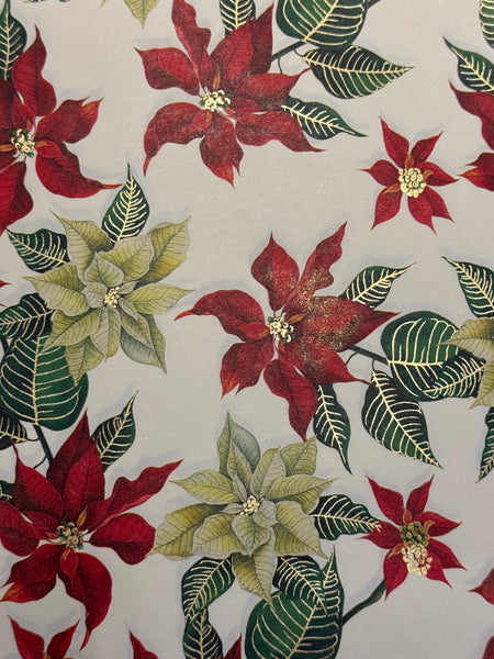 Rossi poinsettia wrapping paper with festive red and green floral design, ideal for holiday gift wrapping.