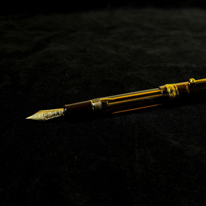 Pilot Custom 823 amber fountain pen with transparent amber resin barrel and gold accents.
