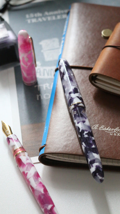 Esterbrook Estie Bestie fountain pen with a pink rose-colored barrel and gold accents on a white background.