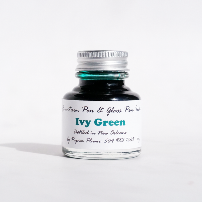 Papier Plume fountain pen ink bottle with Ivy Green colored ink, featuring a glass bottle and label.
