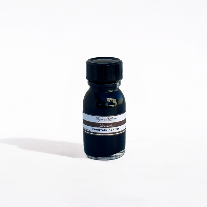 Papier Plume Javalina fountain pen ink bottle with black ink, featuring a sleek glass container and label design.