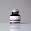 Bottle of Papier Plume Javalina Fountain Pen Ink with a clear label and ink inside, designed for elegant writing and ink flow.