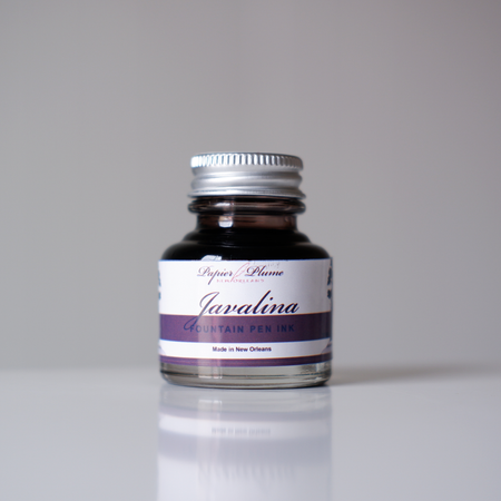 Bottle of Papier Plume Javalina Fountain Pen Ink with a clear label and ink inside, designed for elegant writing and ink flow.