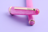 Esterbrook Love Potion Jr fountain pen with pink barrel and gold accents, showcasing its elegant design and smooth writing tip.