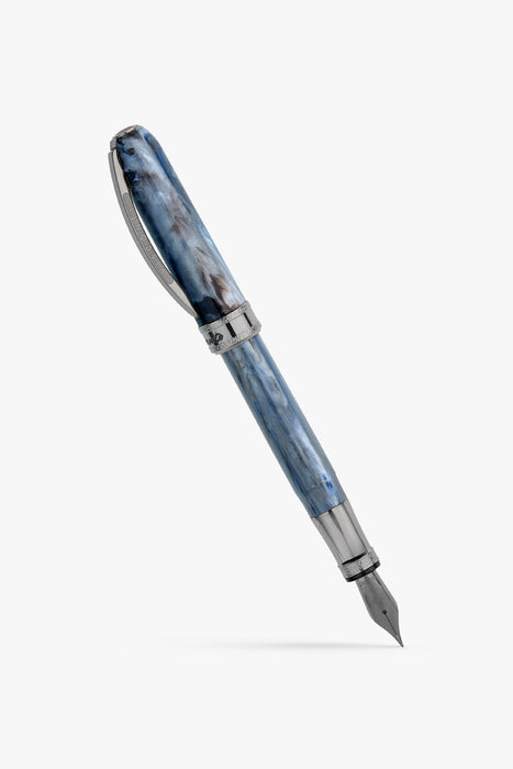 Visconti Comedia Caronte fountain pen with black resin body and gold accents, displayed on a wooden surface.