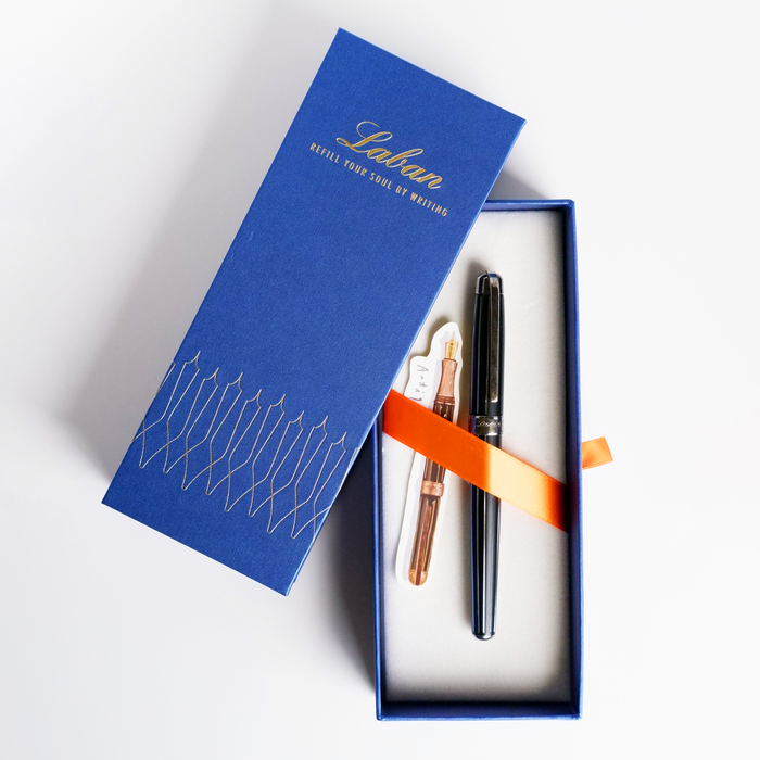 Laban Antique II fountain pen with black and grey resin body, silver accents, and gold nib, showcasing elegant craftsmanship.
