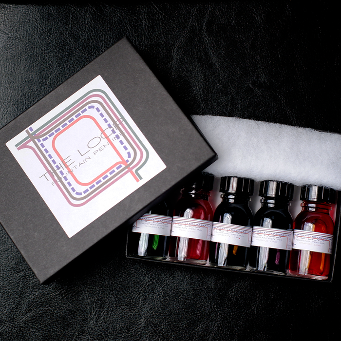 Papier Plume The Loop Series fountain pen ink set with colorful ink bottles displayed on a white background.