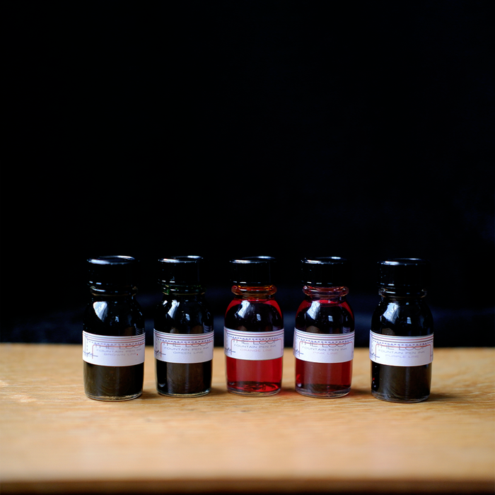 Papier Plume The Loop Series fountain pen ink set with vibrant ink bottles and colorful packaging for writing and art.