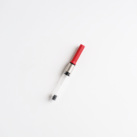 Lamy Z28 converter for ink cartridges, shown in the image, used to fill fountain pens with bottled ink.