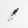 Lamy Z27 converter for ink cartridges, shown in close-up with transparent plastic body and metal twist mechanism.