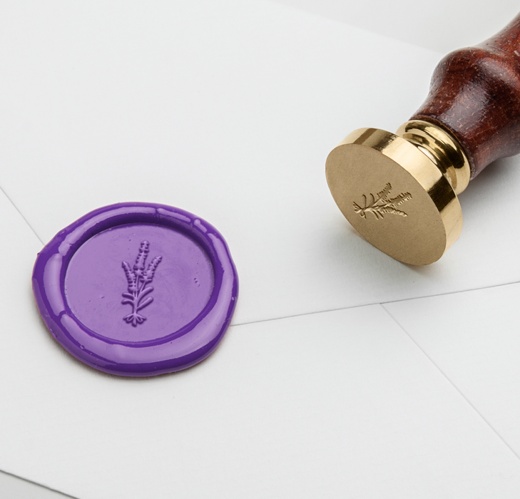 Lavender wax seal with Papier Plume symbol design, used for sealing letters or decorative purposes.