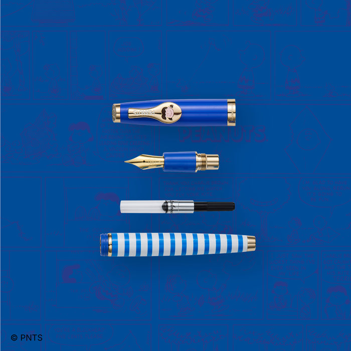 Esterbrook Lucy Estie fountain pen with a colorful comic book-inspired background and intricate gold accents.