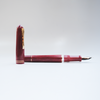 Gioia Luminosa Red fountain pen with a vibrant red illuminated design, showcasing its elegant pen body and nib.