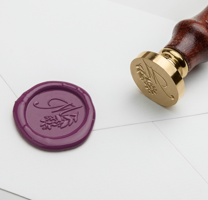 Papier Plume Script Monogram wax seal stamp with M initial design on black inked surface for sealing letters and documents.