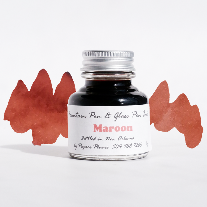 Papier Plume fountain pen ink in maroon, bottle with ink swatch, showcasing rich maroon color for writing and calligraphy.