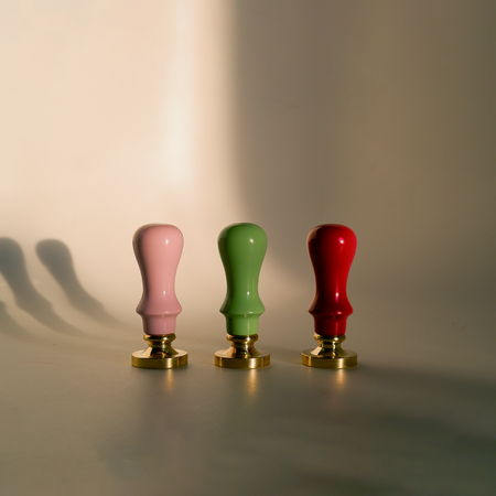 Close-up of Papier Plume mini wood handles used for wax seals, showing their small size and natural wood texture.