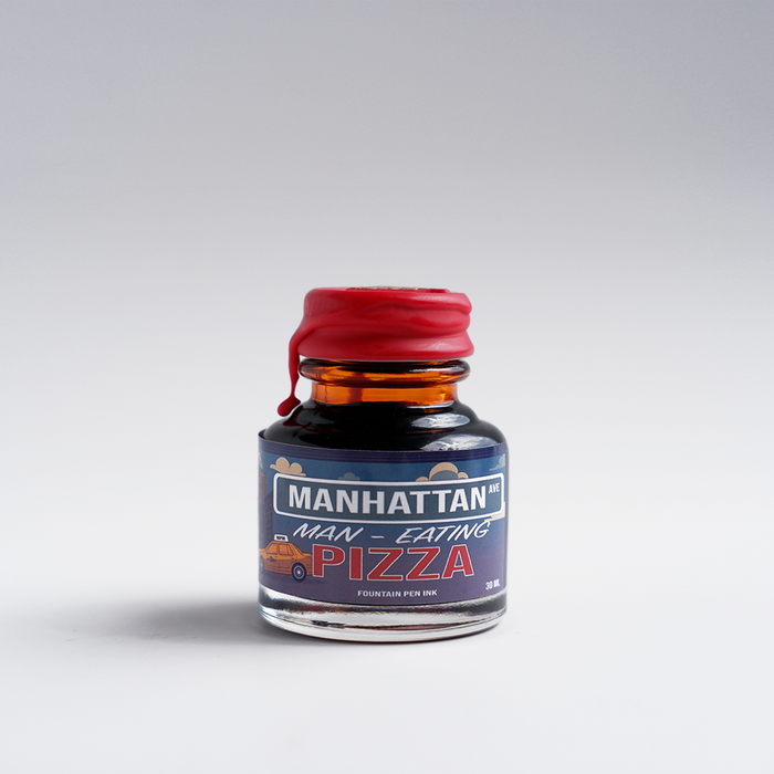 Papier Plume Manhattan Man-Eating Pizza fountain pen ink set featuring vibrant ink bottles with colorful pizza-themed labels.