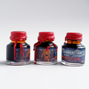 Papier Plume Manhattan Man-Eating Pizza fountain pen ink set with colorful ink bottles and packaging, ideal for writing enthusiasts.
