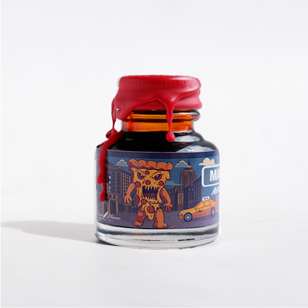 Papier Plume Manhattan Man-Eating Pizza fountain pen ink bottle with pink ink in a clear glass container.
