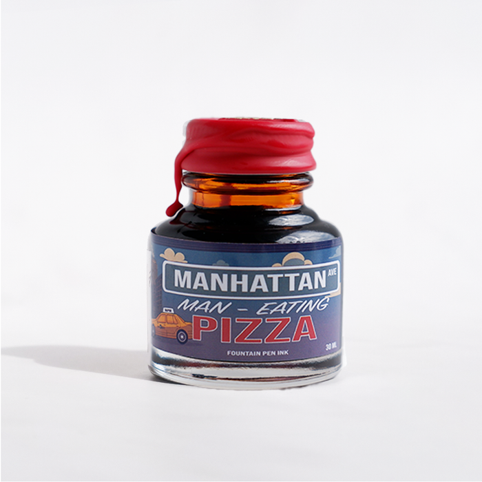 Papier Plume Manhattan Man-Eating Pizza fountain pen ink in a bottle with label, vibrant pink color, and creative design.