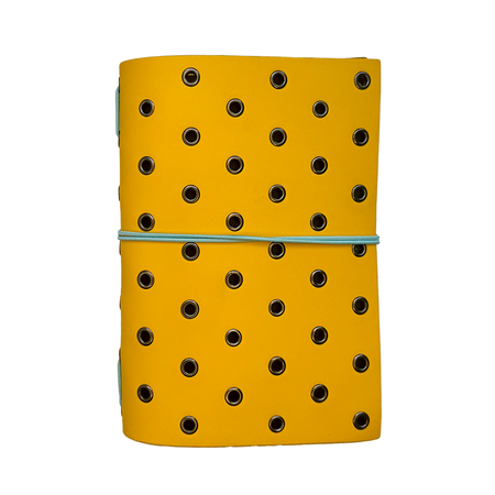 Yellow leather journal cover by Imperfect Concepts with gunmetal grommets, designed for A6 bifold folio notebooks.