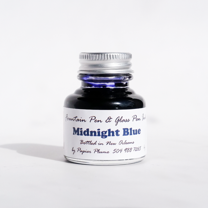 Papier Plume fountain pen ink in a bottle, showcasing rich midnight blue ink suitable for elegant writing and calligraphy.