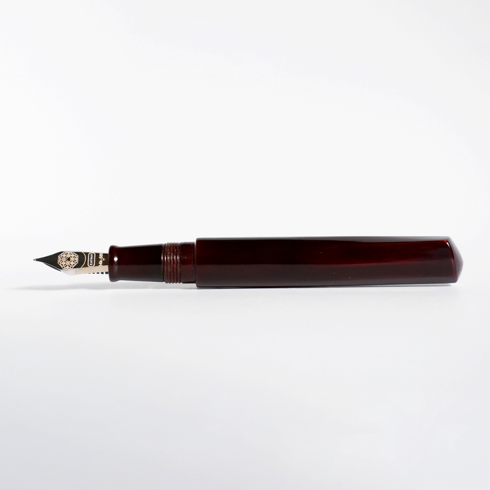 Cathay Diamond Tamenuri fountain pen with a glossy red Aka finish, featuring a sleek design and gold accents on a black background.
