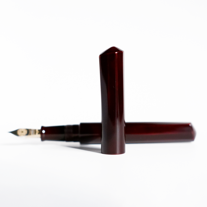 Cathay Diamond Tamenuri fountain pen with red Aka finish, featuring a sleek, polished design and gold accents.