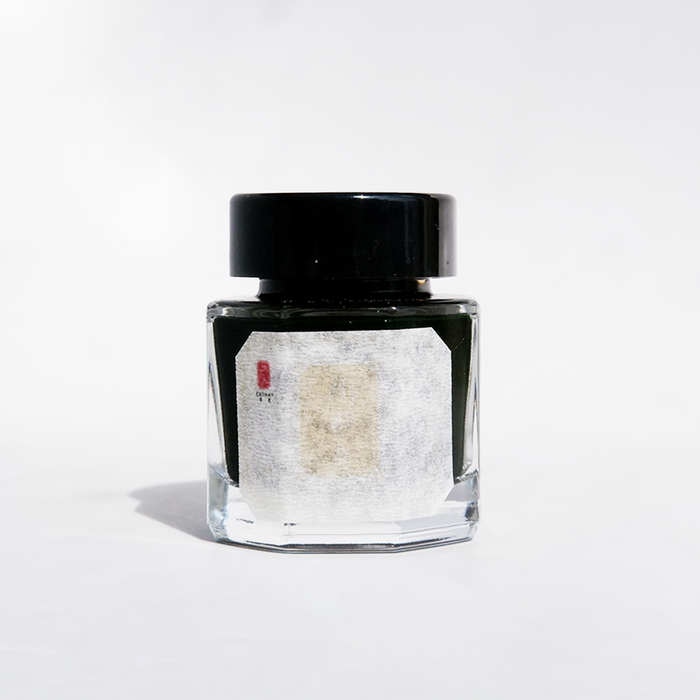 Cathay Moonlit Bronze fountain pen ink bottle with bronze-colored ink visible in the glass container.