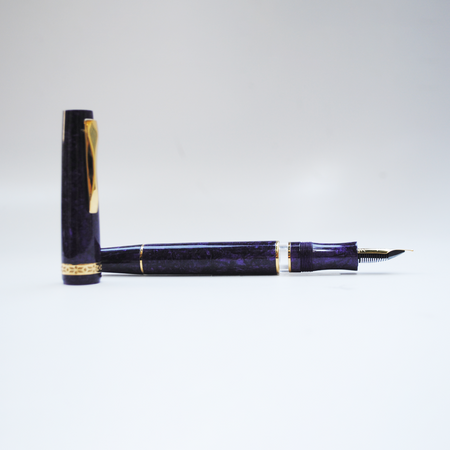 Gioia Metis 2.0 fountain pen in Mystic Purple with a sleek design and gold accents, displayed on a white background.