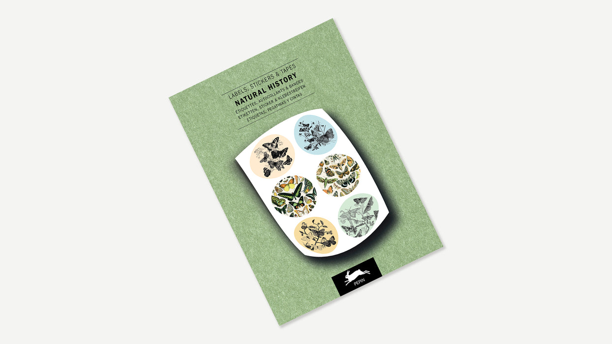 Pepin Press Natural History Sticker and Tape Book open to pages featuring vintage-style botanical and animal illustrations.