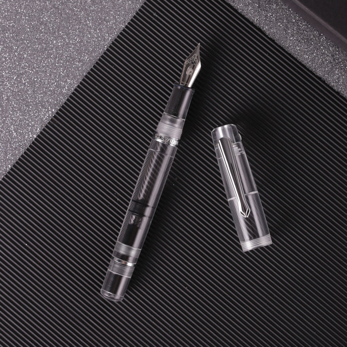 Nahvalur Original Demonstrator Fountain Pen showing transparent body and metal accents on a white background.