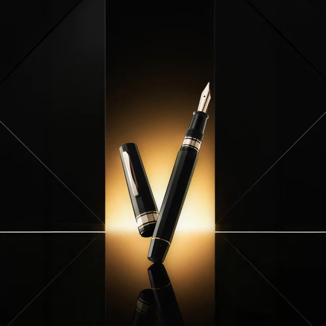 Omas Paragon limited edition fountain pen with sleek design and gold accents, close-up of the pen's body and cap.