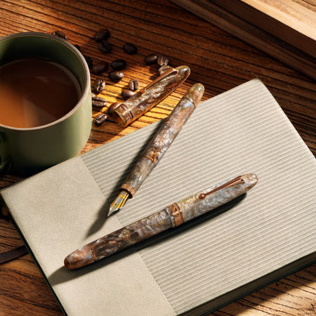 Omas Ogiva limited edition fountain pen inspired by espresso martini, with sleek design and gold accents.
