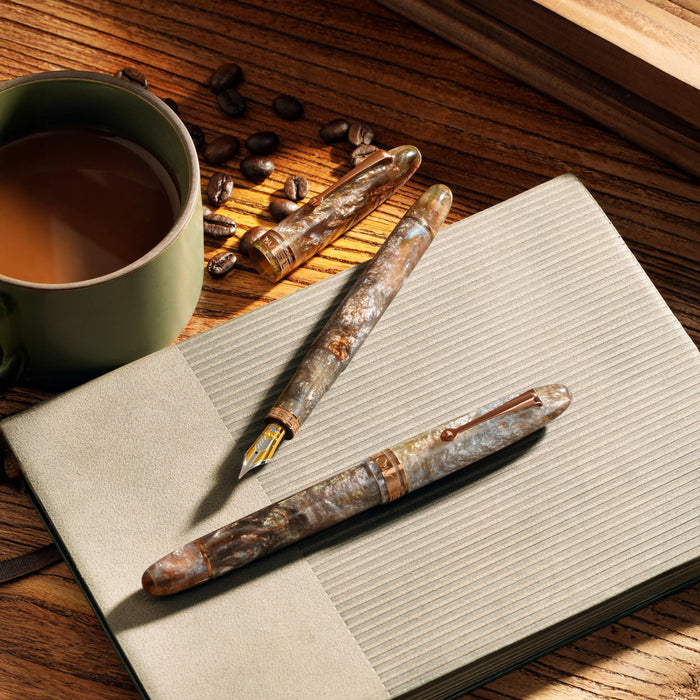 Omas Ogiva limited edition fountain pen inspired by espresso martini, with sleek design and gold accents.